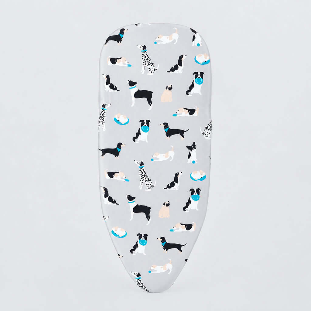 A white ironing board cover featuring a playful pattern of various dog breeds in black, white, and tan, accented with small blue bowls, shown on a clean white background.