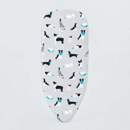 A white ironing board cover featuring a playful pattern of various dog breeds in black, white, and tan, accented with small blue bowls, shown on a clean white background.