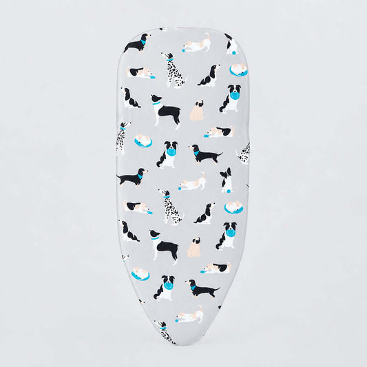 A white ironing board cover featuring a playful pattern of various dog breeds in black, white, and tan, accented with small blue bowls, shown on a clean white background.