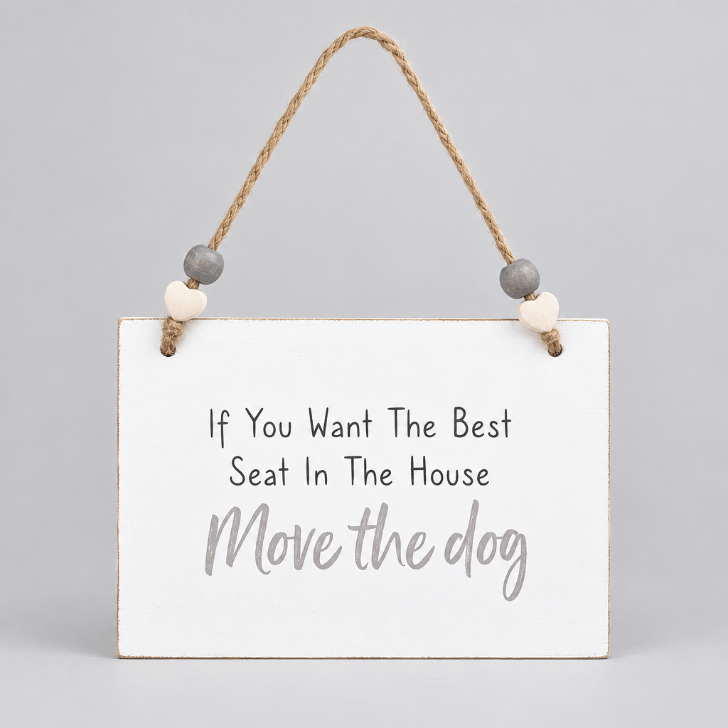 A white rectangular hanging wall sign with the phrase 'If You Want The Best Seat In The House Move the dog' in black and light gray lettering, suspended by a natural jute rope with small gray and cream wooden beads, on a plain white background.